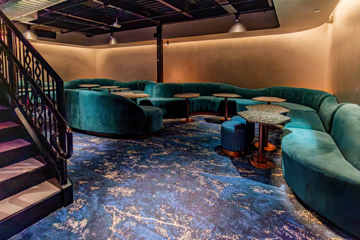 Lounge seating with curved banquettes and custom tables in Florería, Washington, DC.