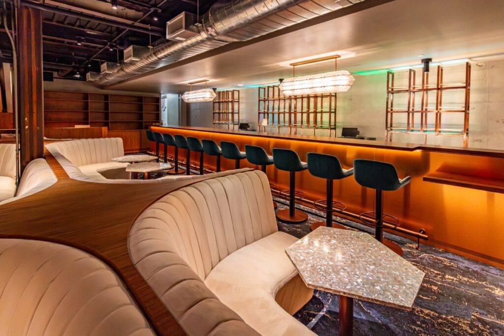 Lounge seating with curved banquettes and custom tables in Florería, Washington, DC.