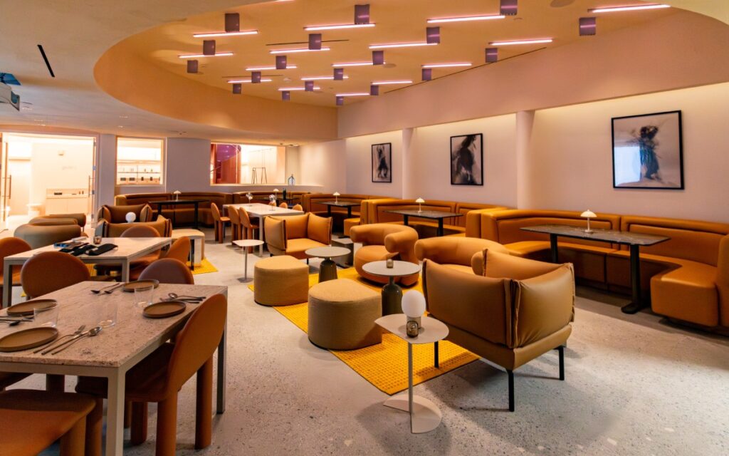 Open lounge with banquette seating, custom furniture, and integrated lighting at Manifest CAW in Washington, DC.